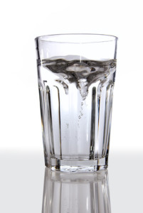 A glass of water on a reflective surface